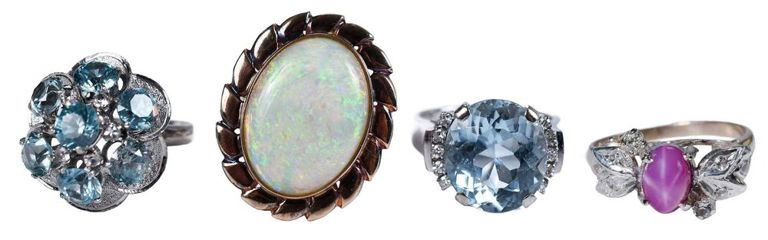 Four gemstone rings: aquamarine, blue topaz, pink star sapphire, opal