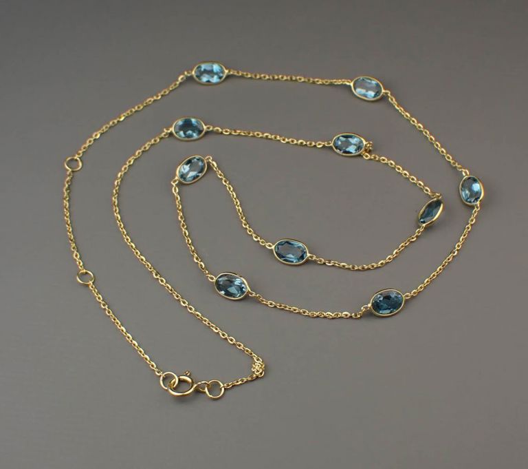 Blue topaz and 18k gold station necklace