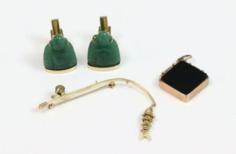14k gold jewelry group with fishing rod pin, buddha cufflinks, and intaglio pendant