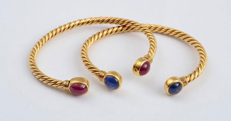 Pair of 18k gold ruby and sapphire bangles