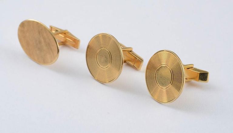 Pair of 14k gold cufflinks and a single cufflink