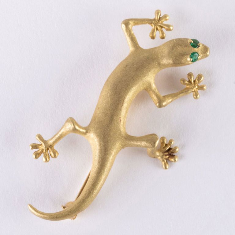 Gold lizard brooch with emerald eyes