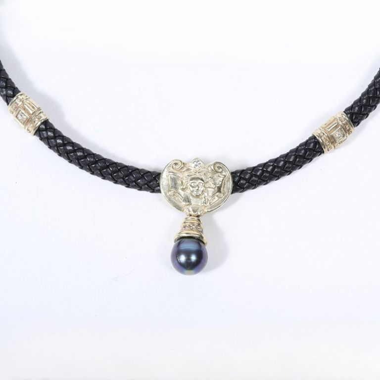 Pearl and diamond pendant on braided leather necklace