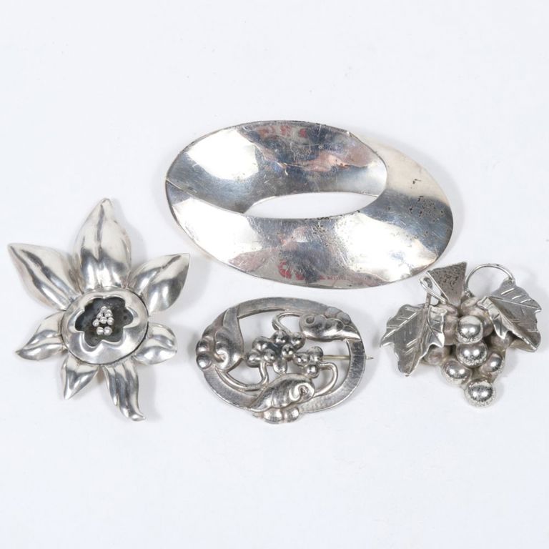Four sterling silver brooches