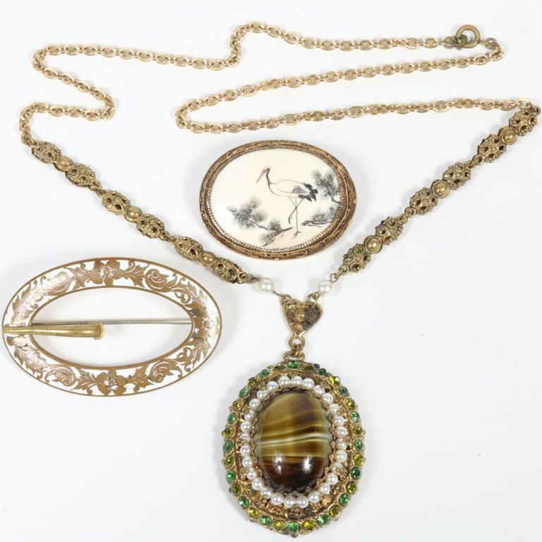 Jewelry set of necklace with pendant and two brooches