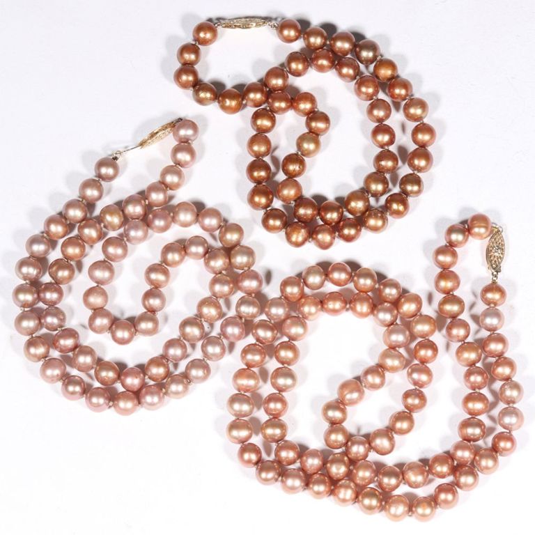 Three pearl strand necklaces with 14K yellow gold clasps.