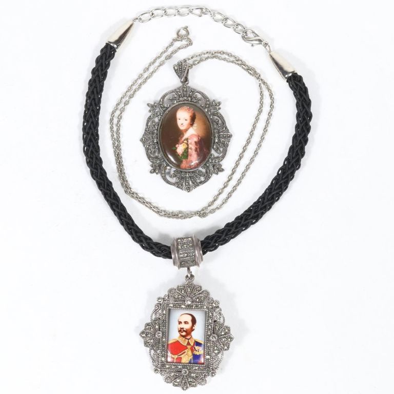 Two sterling silver cameo pendants on necklaces