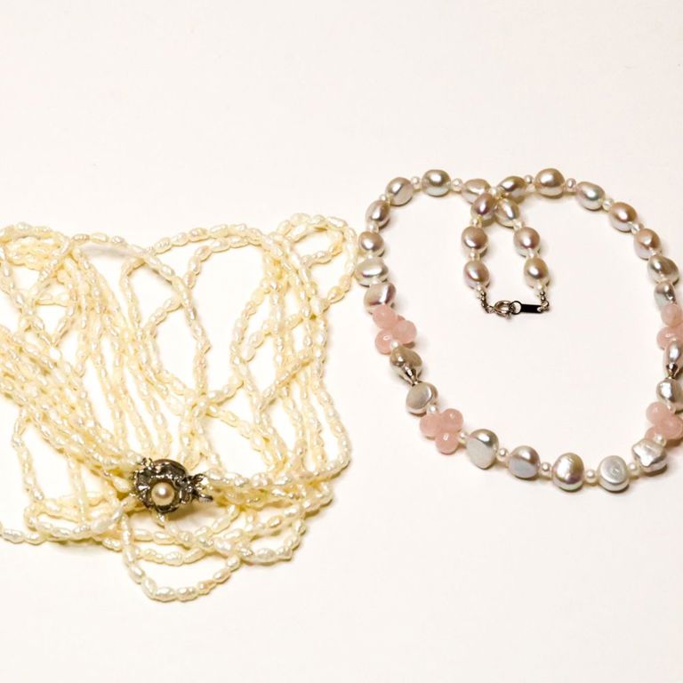 Two pearl necklaces with sterling silver clasps