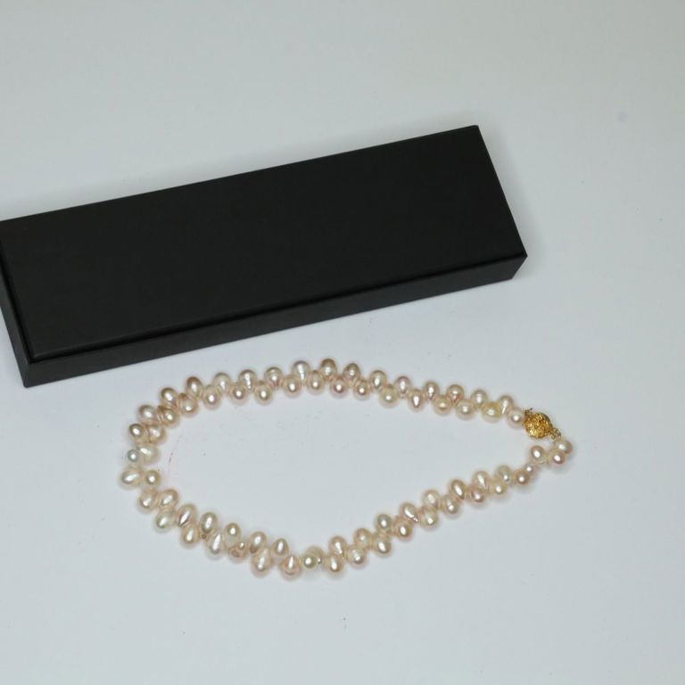 Pearl necklace with gold-toned sterling silver flower clasp