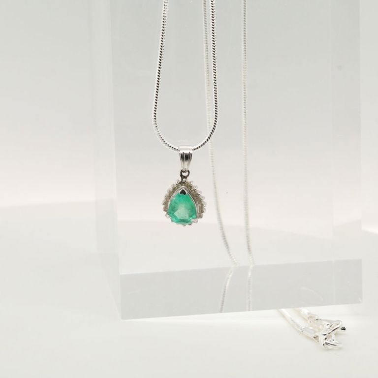 Platinum emerald and diamond pendant on silver necklace
