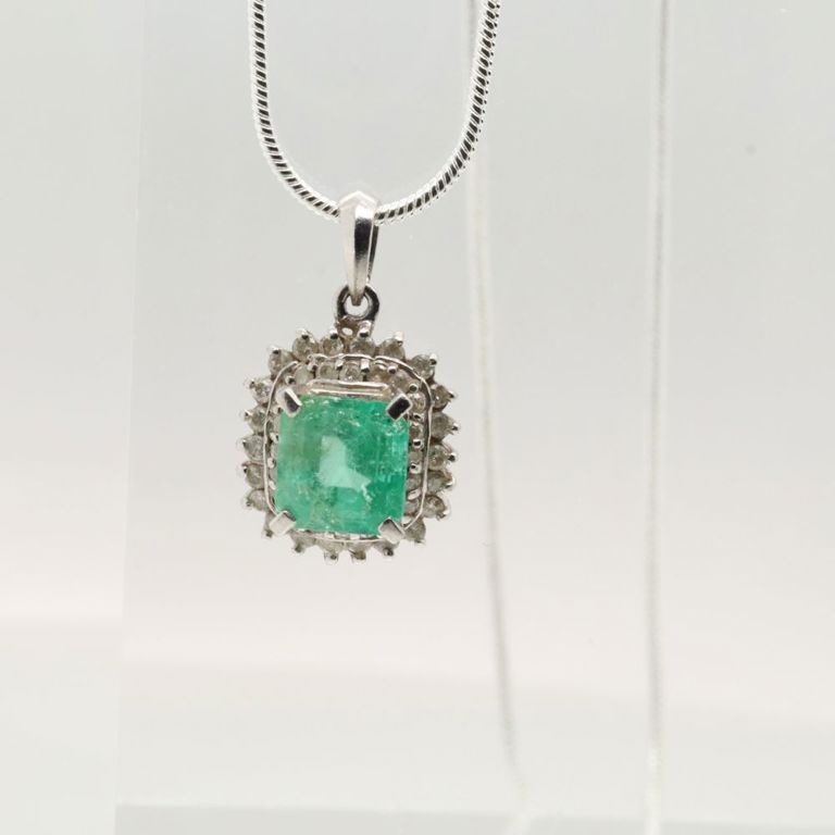 Platinum emerald and diamond pendant on silver necklace