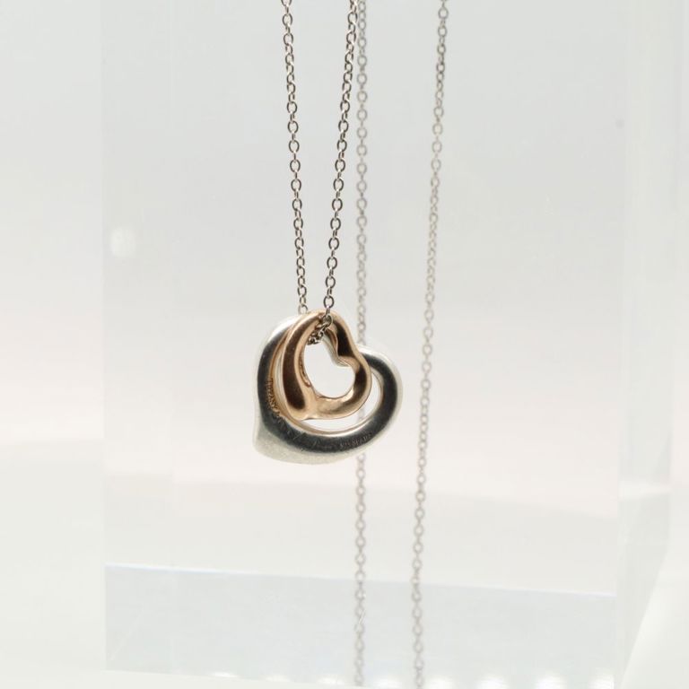 Sterling silver heart pendant on yellow gold necklace