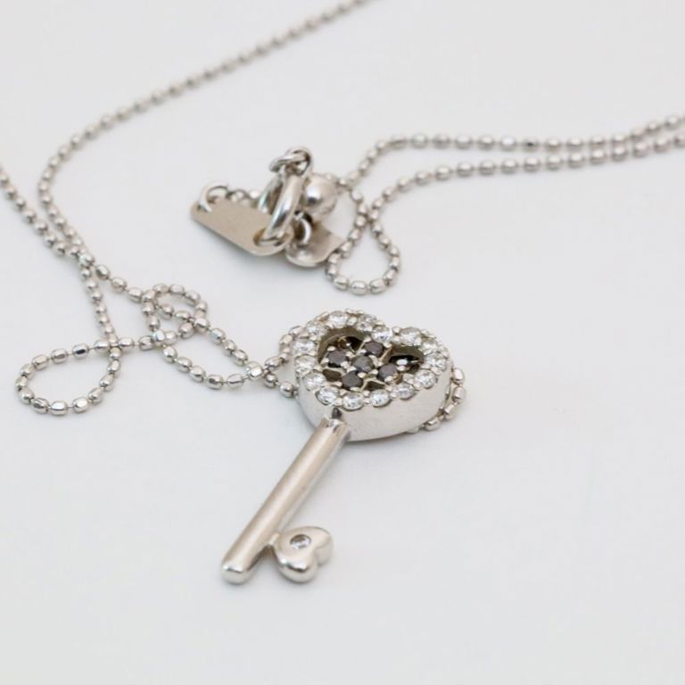 18k white gold necklace with a diamond heart key pendant
