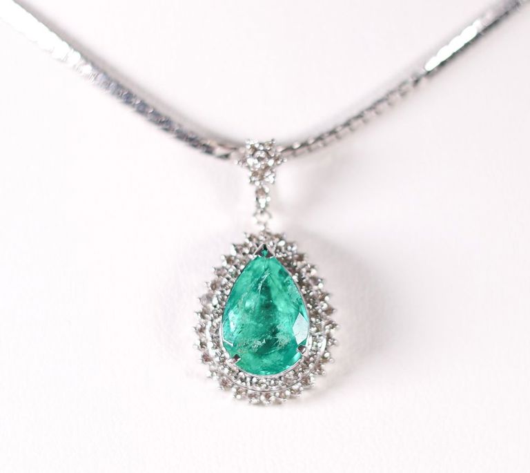 Platinum emerald and diamond pendant on neaklace