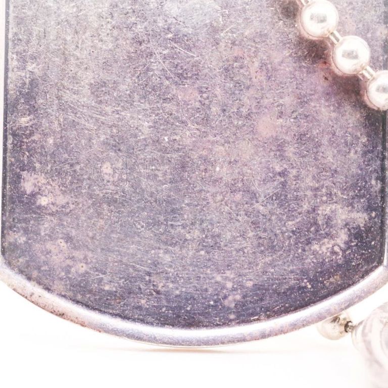 Sterling silver dog tags hung on a sterling silver beaded necklace