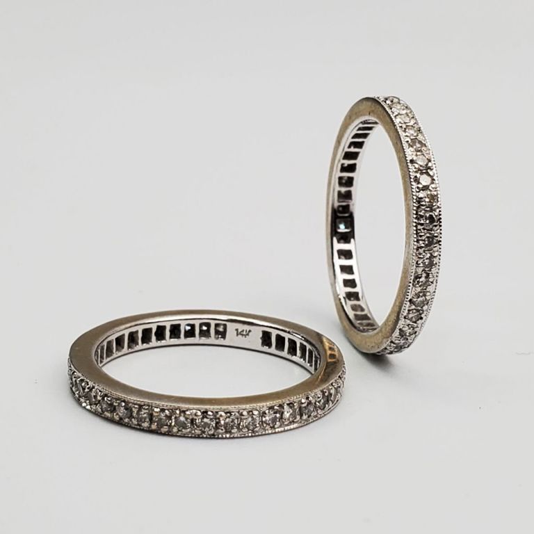 Pair of 14k white gold and diamond eternity bands