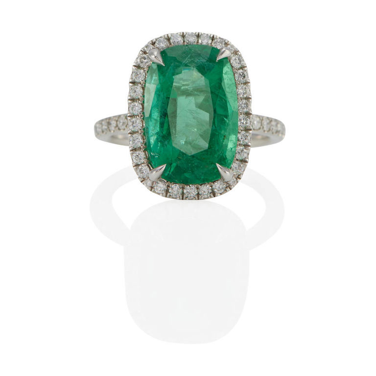 Platinum emerald and diamond halo ring
