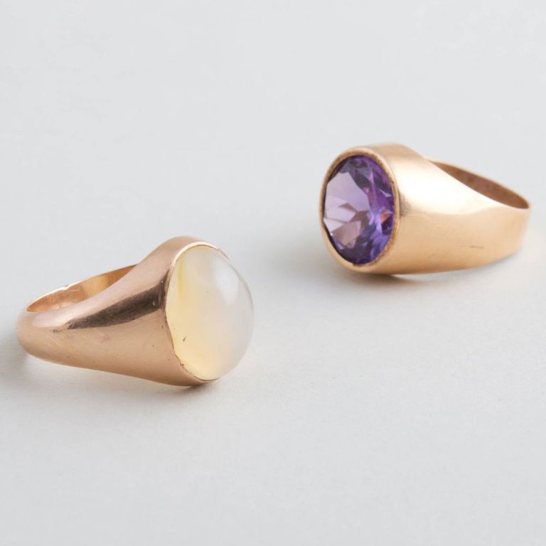 Two gold rings with moonstone and purple gem