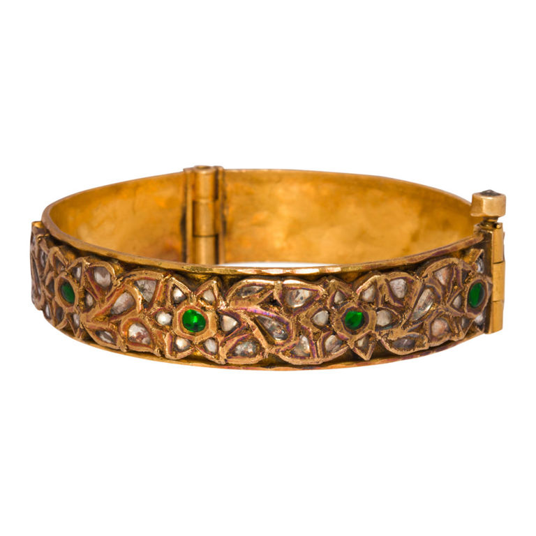 An Indian diamond, emerald and high karat gold bangle bracelet