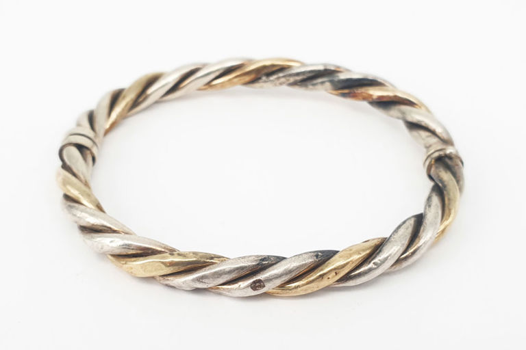 A 14k gold, silver HINGED BANGLE