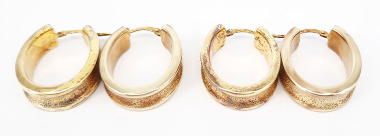 Two pairs of gilt sterling silver hoop earrings
