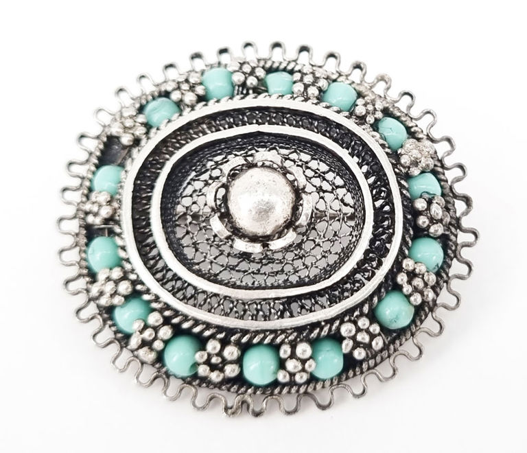 Vintage silver filigree brooch with light blue stone