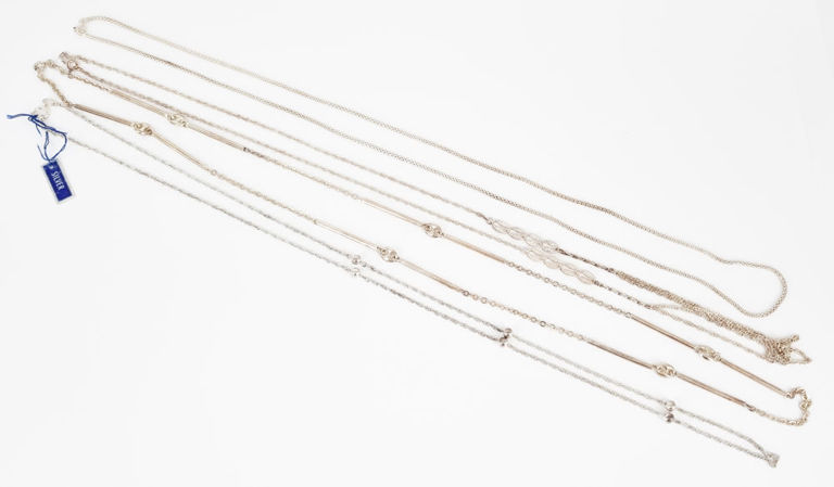 Four long silver chains, various link styles