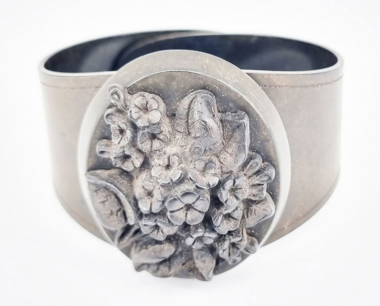 Victorian vulcanite bangle with carved floral plaque