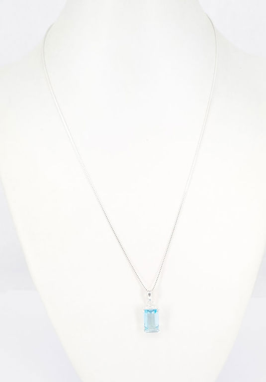 A blue topaz pendant in sterling silver on a chain
