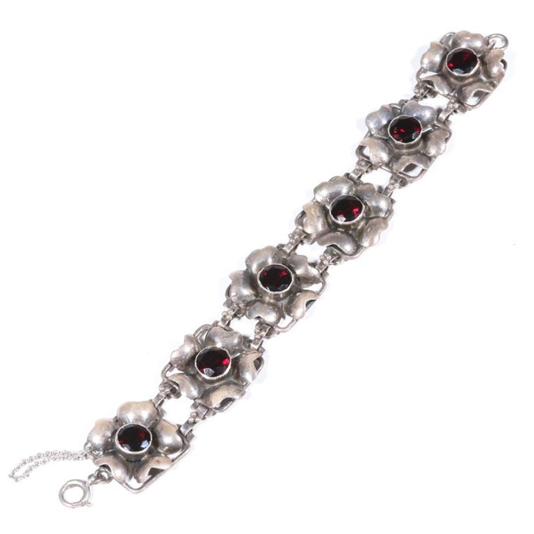 Sterling silver floral panel bracelet with deep garnet colored gems