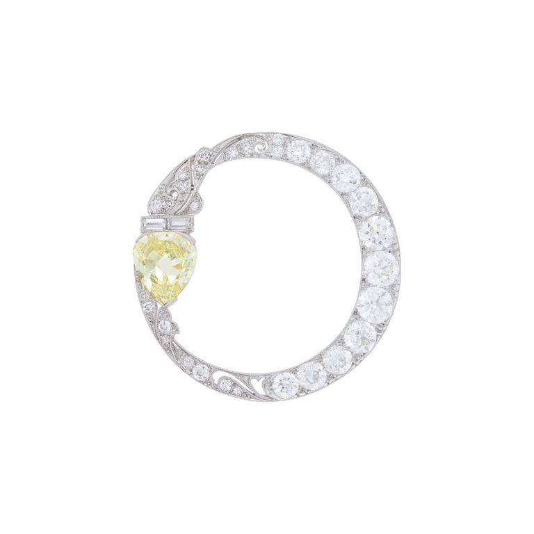 Platinum fancy intense yellow diamond and diamond circle brooch