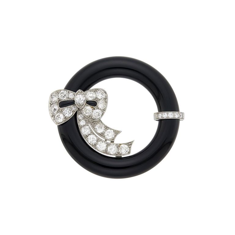 Platinum black onyx and diamond circle bow brooch