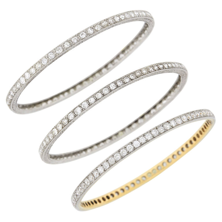 Pair of platinum diamond bangle bracelets and platinum gold diamond bangle bracelet