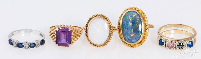 Five gold rings with gemstones