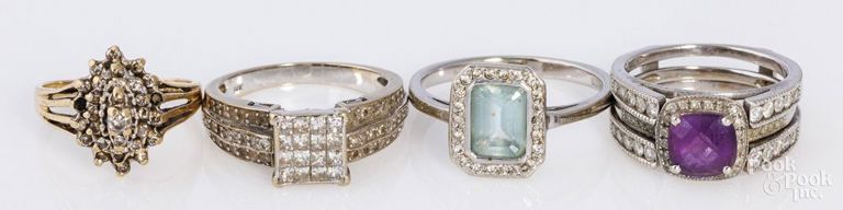 Four gold rings with gemstones