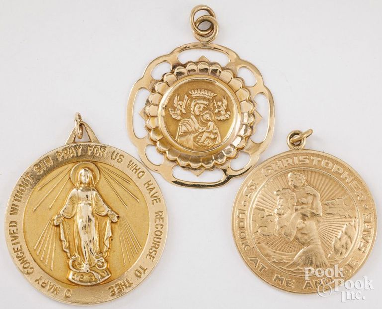 Three 14k yellow gold religious pendants