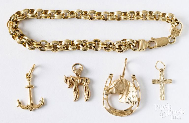 18k yellow gold bracelet and three 14k yellow gold charms
