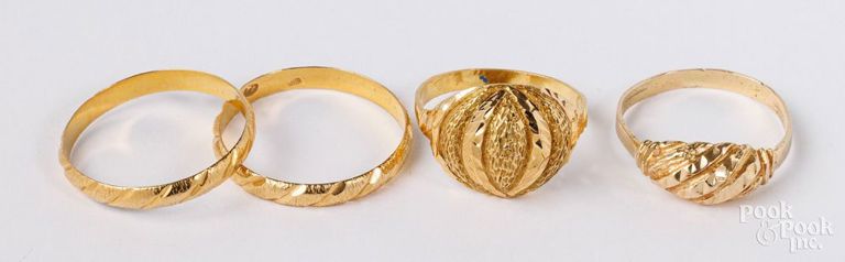 Four 22k yellow gold rings