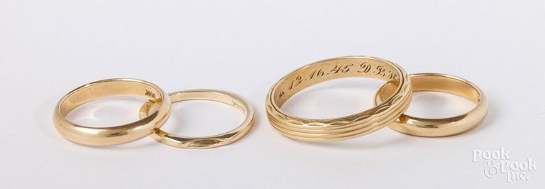 Four 14k yellow gold rings