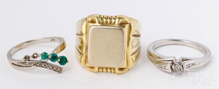 Two gold rins and sterling silver ring