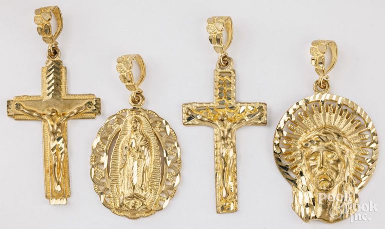 Four 14k yellow gold religious pendants