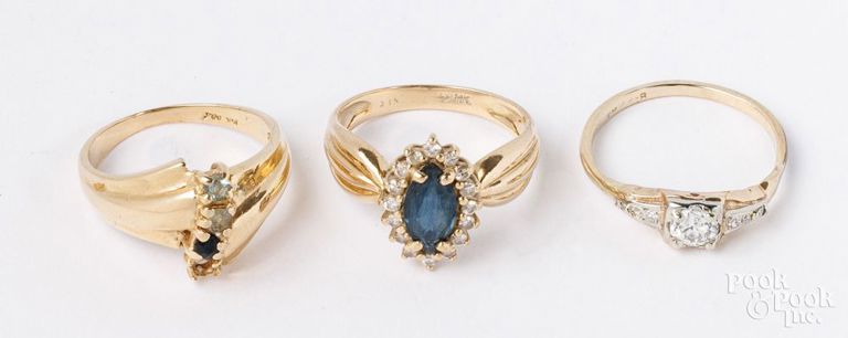 Three gold rings with gemstones