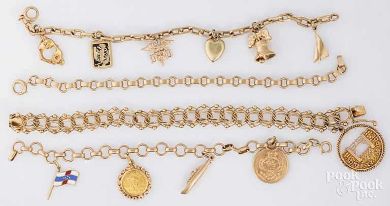 Four 14k yellow gold charm bracelets