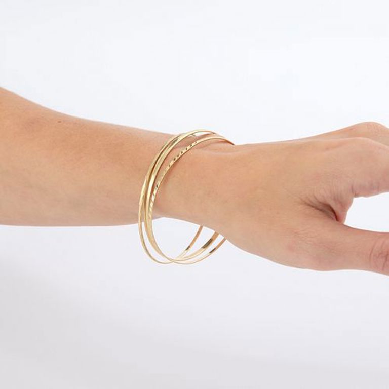 Group of three 14k yellow gold bangles