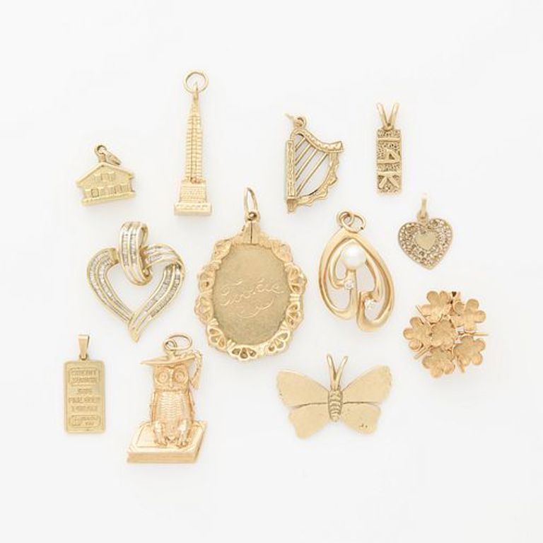 Group of 12 gold pendants and charms