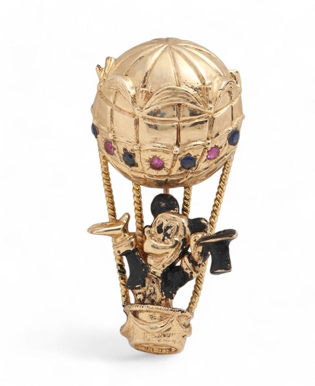 A sapphire, ruby, enamel and gold brooch