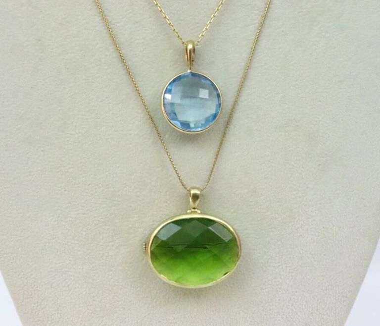 Two 18k gold pin pendants on chains