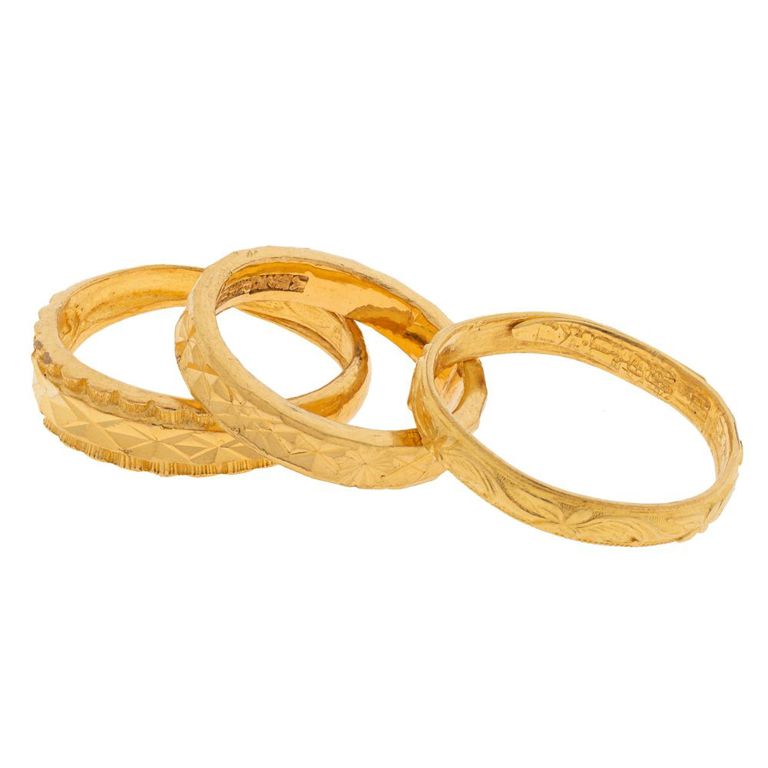 Collection of three 24k and 22k yellow gold rings