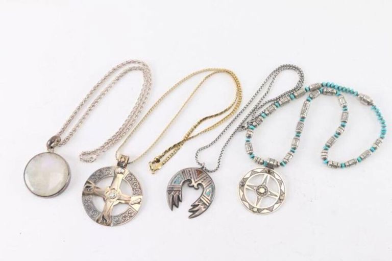 Four sterling silver pendants on necklaces