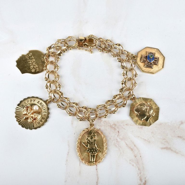 14k yellow gold pearl, ruby and emerald charm bracelet